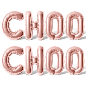 May include: Rose gold foil balloons spelling out "CHOO CHOO" in all caps.