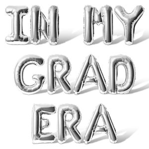 May include: Silver foil balloons spelling out the phrase "IN MY GRAD ERA".