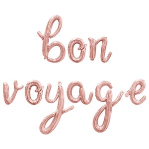 May include: Rose gold foil balloons spelling out "Bon voyage" in a cursive font.