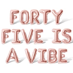 May include: Rose gold foil balloons spelling out "FORTY FIVE IS A VIBE".