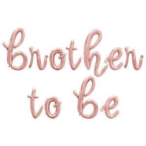 May include: Rose gold foil balloons spelling out "Brother to Be" in a cursive font.