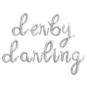 May include: Silver foil balloons spelling out "derby darling" in a cursive font.