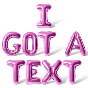 May include: Pink foil balloons spelling out the phrase "I GOT A TEXT".
