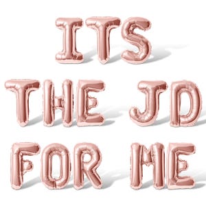 May include: Rose gold foil balloons spelling out the phrase "It's the JD for me".