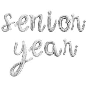 May include: Silver balloon letters spelling out "senior year" in a cursive font.