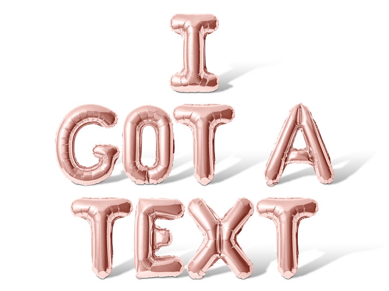 May include: Rose gold foil balloons spelling out the phrase "I GOT A TEXT".