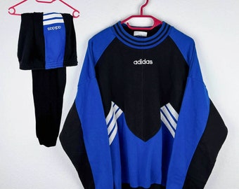 May include: A blue and black Adidas sweatshirt with white stripes and the Adidas logo on the front.