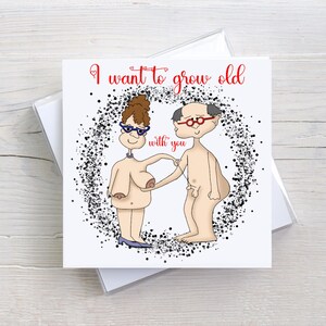 May include: A greeting card featuring a cartoon of an elderly couple, with the text "I want to grow old with you". The couple is depicted nude, with the woman wearing glasses and the man wearing glasses and a toupee. The card is in a clear case.