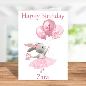 May include: A pink birthday card featuring a bunny wearing a pink tutu and holding pink balloons. The balloons have a pink number 4 and a pink floral pattern. The card reads "Happy Birthday" and "Zara".
