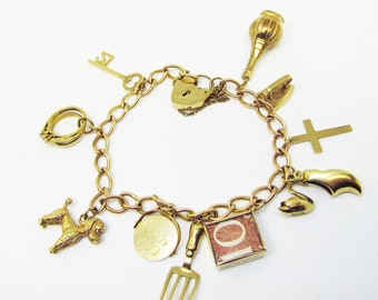 Gold Charm Bracelet with 11 Gold Charms  and Heart Shaped Lock (836)