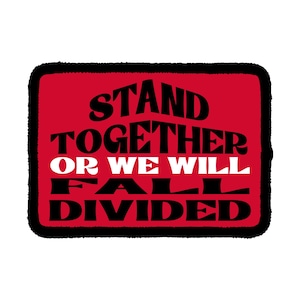 May include: A rectangular patch with a red background and a thick black border. The text reads STAND TOGETHER in black, OR WE WILL in white, and FALL DIVIDED in black. The lettering features a bold, stylized font with a retro, wavy aesthetic.