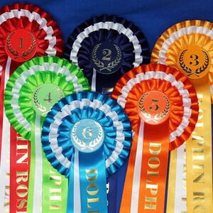 3-tier vibrant rosettes. Wide 15in long printed tails finished to point design, 50mm centres with Laurel place motif. All sports and events. image 3