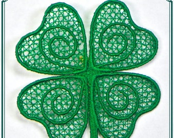 May include: A green four-leaf clover with intricate, swirling designs. The clover is made of a delicate, lace-like material.