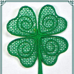 May include: A green four-leaf clover with intricate, swirling designs. The clover is made of a delicate, lace-like material.
