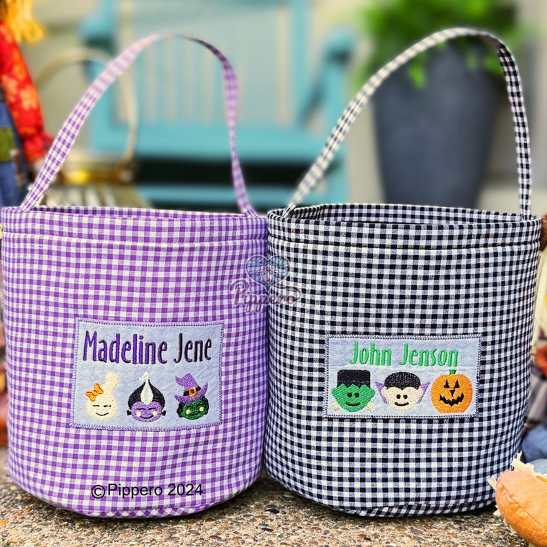 May include: Two gingham fabric Halloween treat bags. One is purple and white, the other is black and white. Each has a rectangular patch with a name and embroidered Halloween characters: a ghost, a vampire, a witch, a Frankenstein, and a pumpkin.