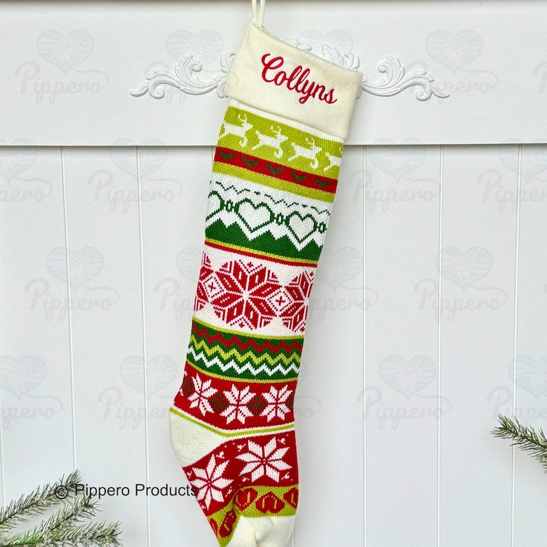 May include: White knitted Christmas stocking with a red, green, and white pattern. The stocking has a white cuff with the name "Collyn's" embroidered in red.