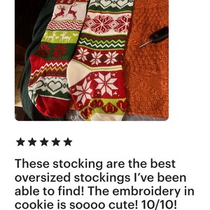 May include: Two red and green Christmas stockings with white snowflakes and reindeer designs. The stockings are personalized with the names "Bitt" and "Sott".