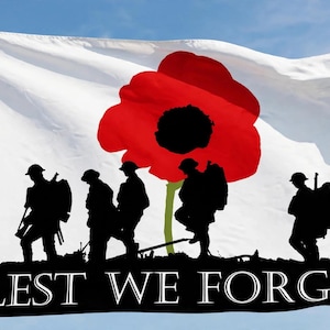 May include: A white flag featuring a large red poppy flower with a black centre, a silhouette of soldiers marching in black, and the text LEST WE FORGET in white capital letters against a black horizontal band at the bottom of the fabric.