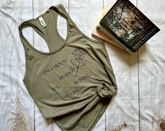 May include: A green tank top with a black rose and the text "I'm a mood it's reader ruining my life".