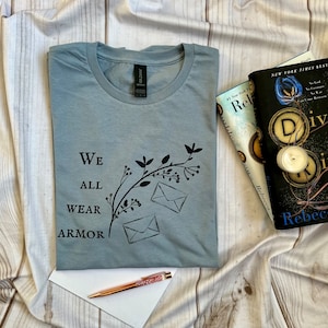 Divine rivals tee, we all wear armor shirt, Roman Kitt, iris winnow, letters of enchantment, fantasy reads, book lover gift, book dragon