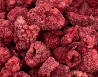 May include: Close-up of a pile of freeze-dried raspberries. The raspberries are a deep red color and have a slightly textured surface. The image is well-lit, showing the details of the fruit.