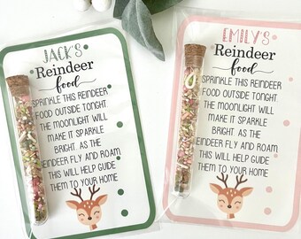May include: Two green and pink cards with reindeer illustrations and text that reads "Jack's Reindeer Food" and "Emily's Reindeer Food".  Each card has a small glass tube filled with colorful sprinkles.