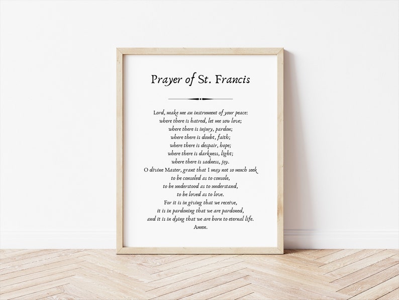 May include: A printable wall art print featuring the Prayer of St. Francis. The text is in black font on a white background. The print is framed in a light wood frame.