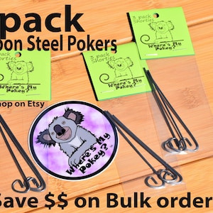 May include: A package of three black carbon steel poker sticks with a green label that says "3 pack Shorties Where's My Pokey? Shop on Etsy" and a sticker with a cartoon koala on it.