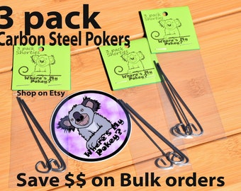 May include: A package of three black carbon steel poker sticks with a green label that says "3 pack Shorties Where's My Pokey? Shop on Etsy" and a sticker with a cartoon koala on it.