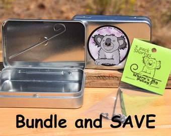 May include: A silver metal tin with a koala cartoon on the lid. The tin is open and has a small metal hook inside. A clear plastic bag with three metal hooks and a green card with the text "Where's My Pokey?" and a koala cartoon. The text "3 pack Shorties" is on the card. The text "Bundle and SAVE" is at the bottom of the image.