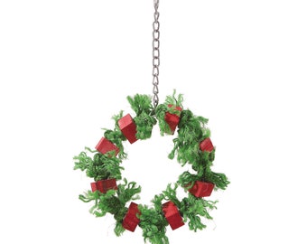May include: A green and red bird toy shaped like a wreath with a metal chain for hanging.
