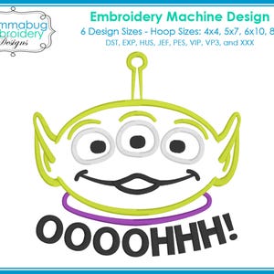 May include: An embroidery machine design featuring a green alien with three eyes, a purple collar, and the word "OOOOHHH!" in black. The design includes the text "Embroidery Machine Design" and "Mommabug Embroidery Designs".