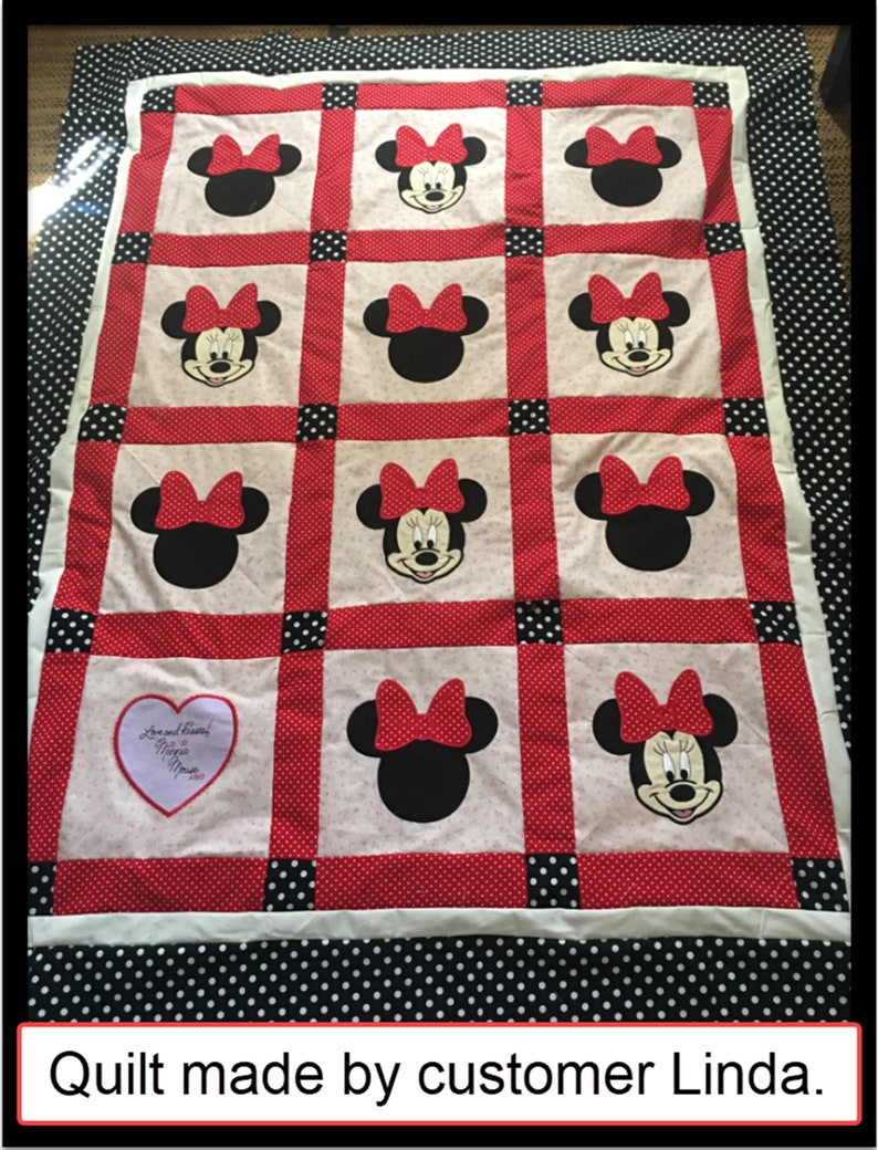 May include: A handmade quilt featuring Minnie Mouse. The quilt has a white background with red polka dot borders and black polka dot edging. Minnie Mouse's face and bow are prominently displayed in the quilt's design.