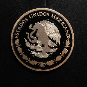 Hand enamelled Mexican 10 peso from 2007 black background