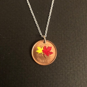 Hand enamelled Canadian penny pendant done with red and yellow leaves
