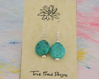 Turquoise Pebbles are created with Smooth Turquoise Coin Beads with Silver Plated Heishe Spacer Beads and Sterling Silver French Ear Wires