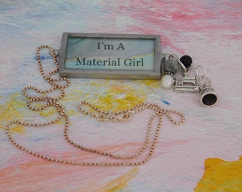 I’m A Material Girl Soldered Pendant is Created with Blue Marble Paper with Sewing Machine and Thimble Pewter Charms and Beads