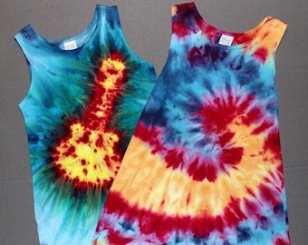 May include: Two tie-dye tank tops, one with a swirl pattern and the other with a guitar design. The tops are in shades of blue, red, yellow, and orange.
