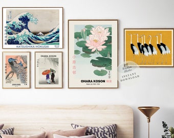 May include: A collection of framed Japanese art prints featuring iconic imagery. The prints include a depiction of a large wave, a peacock, figures under an umbrella, water lilies, and cranes. The prints are in gold frames.