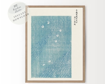 May include: A blue and white Japanese woodblock print depicting a flock of white birds flying over a blue and white patterned background. The print is framed in a light wood frame. The text in the image reads "石黒忠信 木版画 中", which translates to "Stone Black Faithful Trust Woodblock Print Middle".