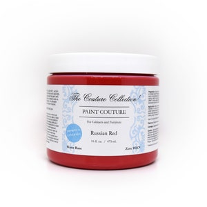 May include: A red, 16-ounce jar of water-based paint labeled "The Couture Collection! Paint Couture for Cabinets and Furniture Russian Red 16 fl. oz. / 473 ml. Zero VOC" with a blue and white floral design on the label. The jar has a white lid and a blue circle with the words "Improved Coverage" on it.