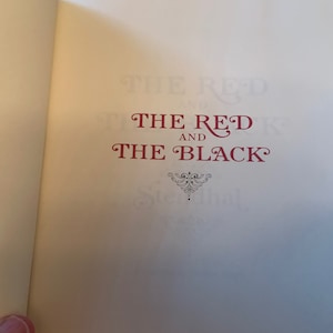 May include: The cover of a book titled "The Red and The Black" with a decorative flourish below the title.