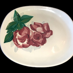 May include: White oval ceramic dish with a hand-painted design of pink roses and green leaves.