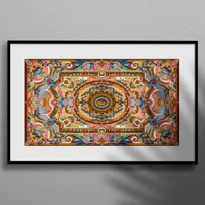 May include: A framed print of a colourful, intricate, symmetrical design with a central eye motif. The design features floral and geometric patterns in shades of blue, green, yellow, orange, and red.