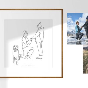 May include: A framed line art print depicts a marriage proposal scene with a dog. The artwork features two figures, one kneeling, holding hands, and a dog. Two additional photos show the proposal and the dog. The frame is brown.