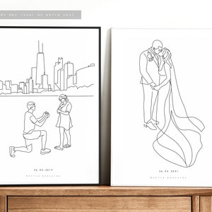 May include: Two framed line art prints. One depicts a proposal scene with a city skyline, the other a kissing couple. Both are black and white, with dates and names below the images. The frames are black.