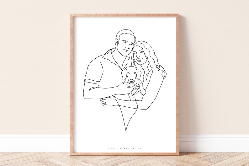 May include: A framed line art print featuring a couple embracing a small dog. The black line drawing style depicts the figures in a minimalist, modern aesthetic. The artwork is set against a white background, framed in a light wood.