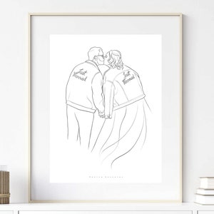 May include: A black and white line drawing of a couple kissing. They are both wearing jackets that say "Just Married" on the back. The drawing is framed in a white frame.