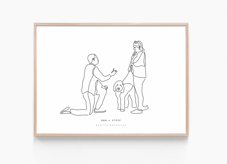 May include: A framed line art print featuring a marriage proposal scene. A man kneels before a woman holding a dog on a leash. The print is in black lines on a white background, with the names "NAN + STEVE" at the bottom.