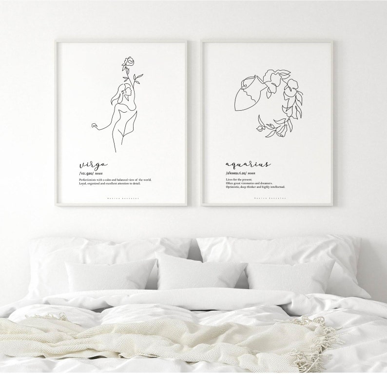 May include: Two framed art prints featuring minimalist line drawings of the Virgo and Aquarius zodiac signs. The Virgo print depicts a woman holding a flower, while the Aquarius print shows a water bearer. Each print includes the sign's name and a brief description.